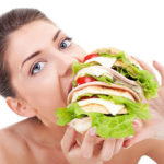 woman eating giant sandwich